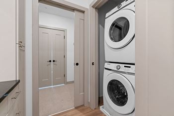 a white washer and dryer in a laundry room with a door